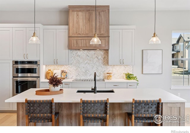 1425 Burt Ave, Berthoud, CO 80513 - kitchen with stainless steel double oven, tasteful backsplash, and light countertops