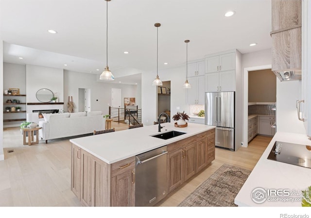 1425 Burt Ave, Berthoud, CO 80513 - kitchen with stainless steel appliances, a sink, light wood-style flooring, light countertops, and recessed lighting