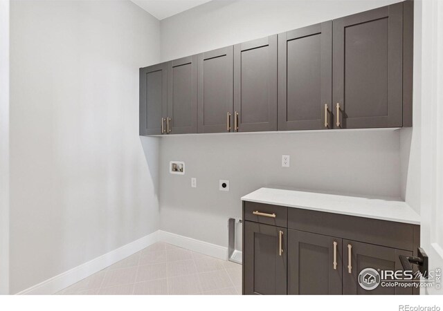 1425 Burt Ave, Berthoud, CO 80513 - washroom featuring cabinet space, hookup for an electric dryer, hookup for a washing machine, and baseboards