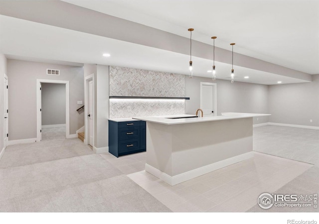 1425 Burt Ave, Berthoud, CO 80513 - kitchen with blue cabinets, light colored carpet, light countertops, recessed lighting, and hanging light fixtures