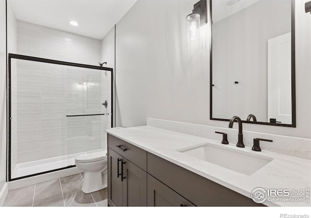 1425 Burt Ave, Berthoud, CO 80513 - full bathroom featuring toilet, vanity, a shower stall, and recessed lighting