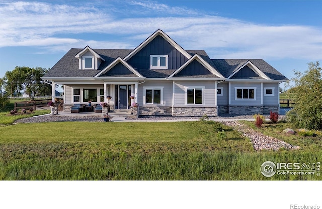 505 Nesting Eagles Way, Berthoud, CO 80513 - craftsman house featuring a front lawn, stone siding, covered porch, and board and batten siding
