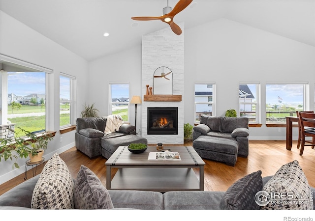 505 Nesting Eagles Way, Berthoud, CO 80513 - living area with high vaulted ceiling, healthy amount of natural light, baseboards, and a fireplace