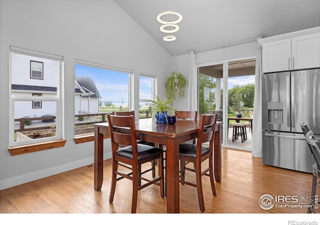 505 Nesting Eagles Way, Berthoud, CO 80513 - dining room featuring high vaulted ceiling, light wood-style floors, and baseboards