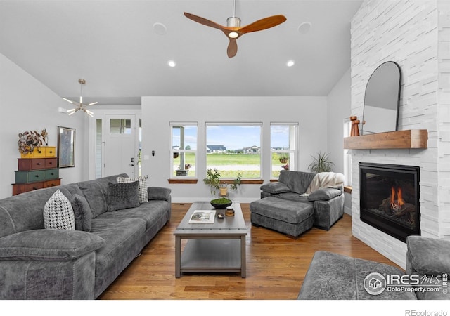 505 Nesting Eagles Way, Berthoud, CO 80513 - living area with a fireplace, high vaulted ceiling, a ceiling fan, wood finished floors, and recessed lighting