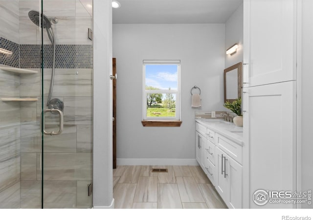 505 Nesting Eagles Way, Berthoud, CO 80513 - bathroom featuring double vanity, a shower stall, baseboards, and recessed lighting