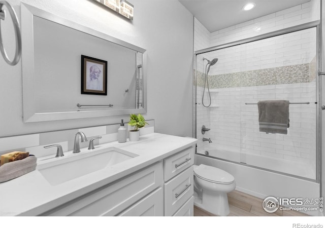 505 Nesting Eagles Way, Berthoud, CO 80513 - bathroom with vanity, toilet, combined bath / shower with glass door, wood finished floors, and recessed lighting