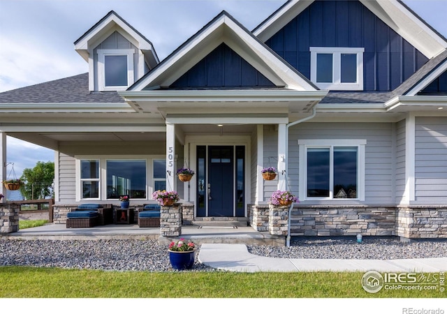 505 Nesting Eagles Way, Berthoud, CO 80513 - doorway to property with a porch, stone siding, roof with shingles, and board and batten siding