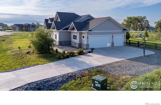 505 Nesting Eagles Way, Berthoud, CO 80513 - craftsman house featuring stone siding, concrete driveway, a garage, roof with shingles, and board and batten siding
