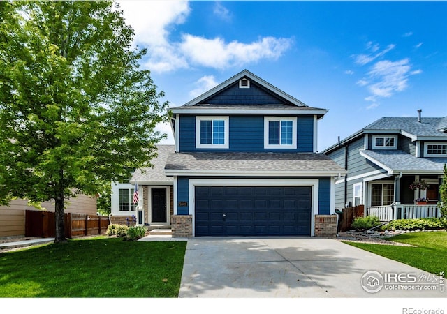 5609 Mount Sanitas Ave, Longmont, CO 80503 - view of front of home with a garage, concrete driveway, brick siding, and roof with shingles