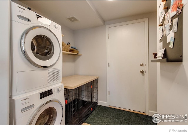 5609 Mount Sanitas Ave, Longmont, CO 80503 - washroom featuring stacked washing machine and dryer and baseboards