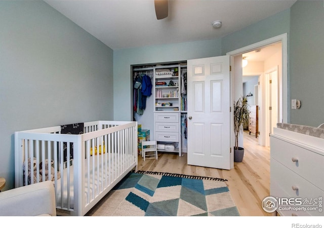 5609 Mount Sanitas Ave, Longmont, CO 80503 - bedroom with wood finished floors, a closet, a nursery area, and ceiling fan