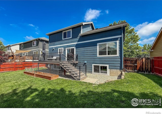 5609 Mount Sanitas Ave, Longmont, CO 80503 - rear view of house featuring a vegetable garden, stairway, and a wooden deck
