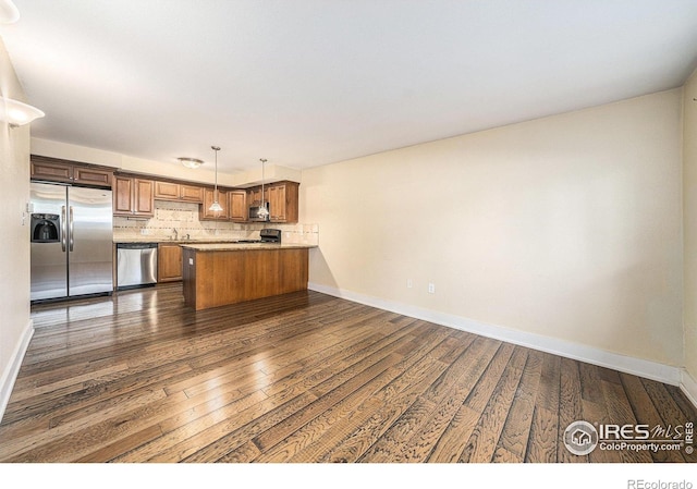 233 N Meldrum St Unit 8, Fort Collins, CO 80521 - kitchen with stainless steel appliances, a peninsula, dark wood finished floors, and baseboards
