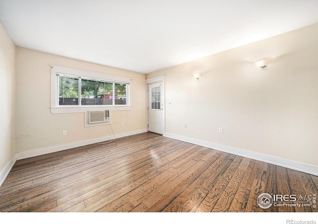 233 N Meldrum St Unit 8, Fort Collins, CO 80521 - spare room with wood finished floors, baseboards, and an AC wall unit