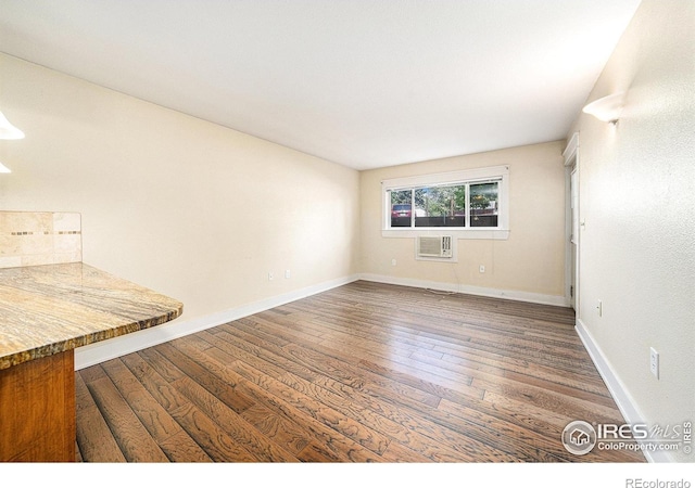 233 N Meldrum St Unit 8, Fort Collins, CO 80521 - spare room with a wall mounted air conditioner, wood finished floors, and baseboards