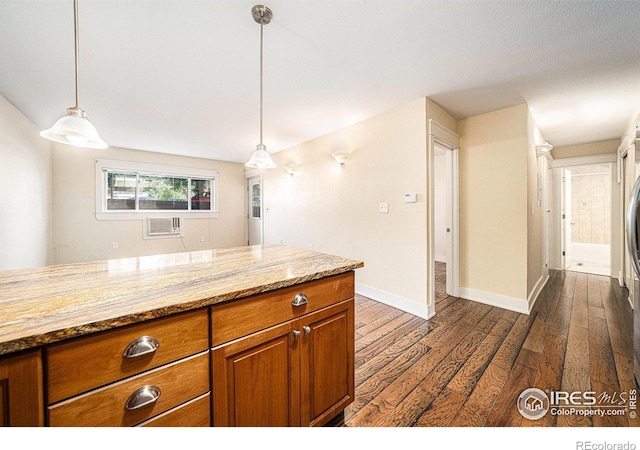 233 N Meldrum St Unit 8, Fort Collins, CO 80521 - kitchen featuring brown cabinetry, dark wood-style floors, a wall mounted air conditioner, and hanging light fixtures