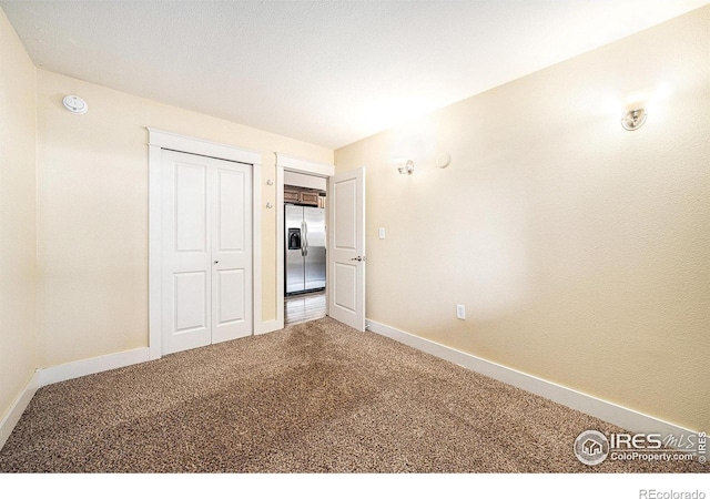 233 N Meldrum St Unit 8, Fort Collins, CO 80521 - unfurnished bedroom with stainless steel fridge, carpet floors, baseboards, and a closet