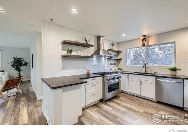 1498 Wicklow St, Boulder, CO 80303 - kitchen with stainless steel appliances, wall chimney range hood, open shelves, tasteful backsplash, and recessed lighting