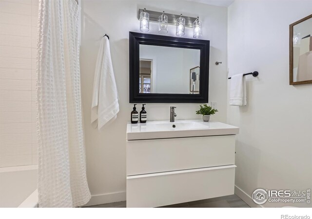 1498 Wicklow St, Boulder, CO 80303 - bathroom featuring vanity and shower / bathtub combination with curtain