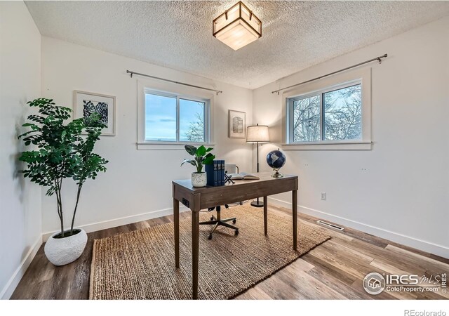 1498 Wicklow St, Boulder, CO 80303 - office with healthy amount of natural light, a textured ceiling, and wood finished floors