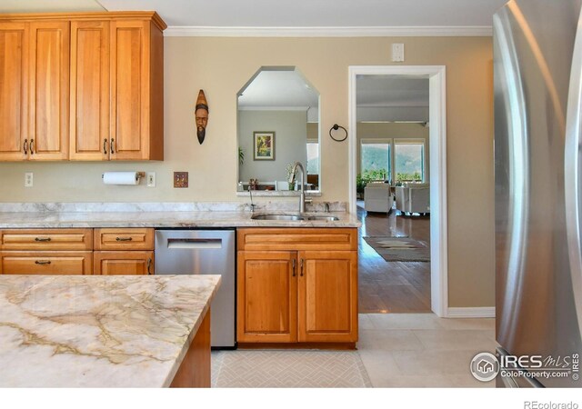 1960 Colard Ln, Lyons, CO 80540 - kitchen with stainless steel appliances, ornamental molding, arched walkways, light stone counters, and brown cabinetry