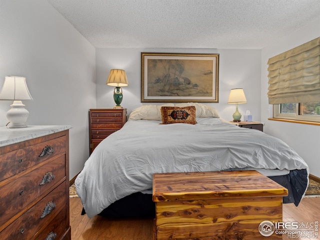 621 Landers St, Estes Park, CO 80517 - bedroom featuring light wood-type flooring and a textured ceiling