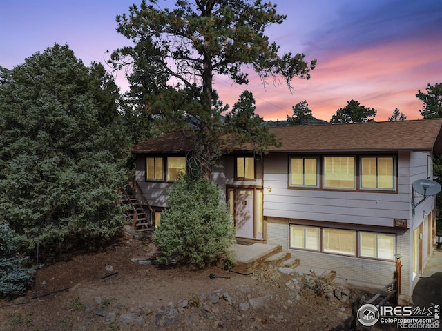 621 Landers St, Estes Park, CO 80517 - bi-level home featuring brick siding and a shingled roof