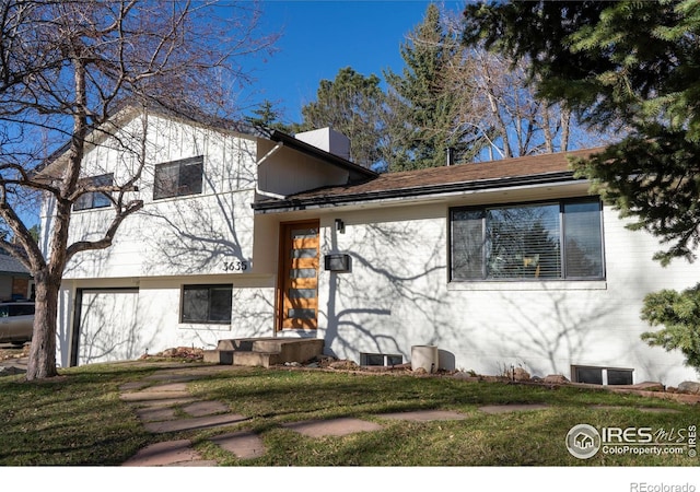 3635 Buckeye Ct, Boulder, CO 80304 - tri-level home with a front lawn and a chimney