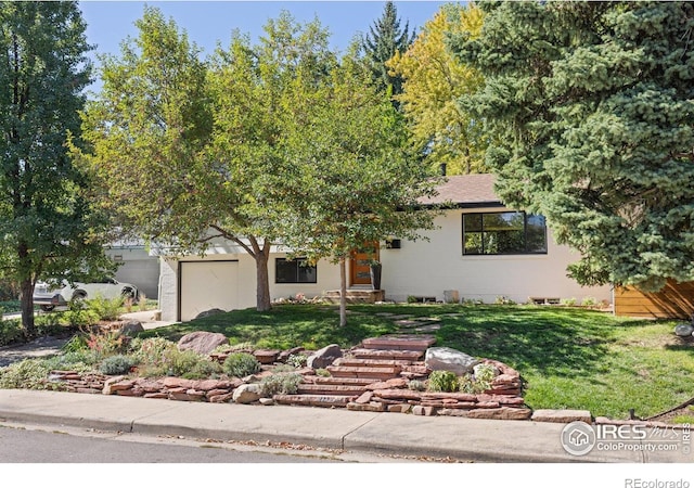 3635 Buckeye Ct, Boulder, CO 80304 - obstructed view of property with a front lawn and an attached garage