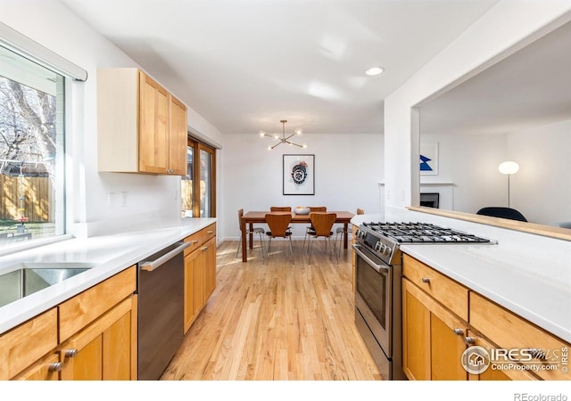 3635 Buckeye Ct, Boulder, CO 80304 - kitchen with appliances with stainless steel finishes, light wood finished floors, a chandelier, light countertops, and recessed lighting