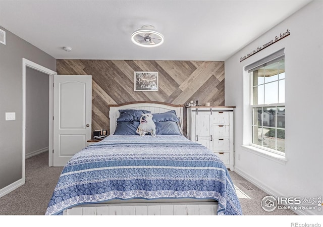 1451 Red Fox Cir, Severance, CO 80550 - carpeted bedroom with wood walls and an accent wall
