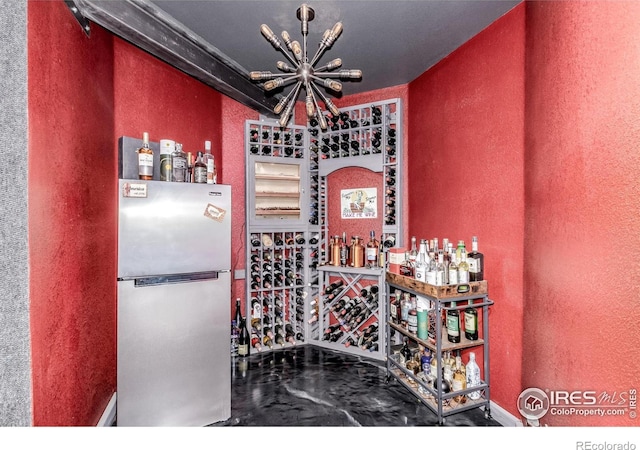 1451 Red Fox Cir, Severance, CO 80550 - wine area with a textured wall and a chandelier