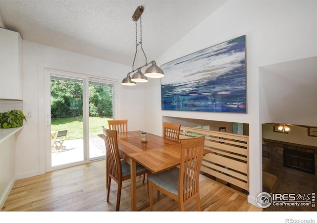 137 S Polk Ave, Louisville, CO 80027 - dining area featuring light wood finished floors, a textured ceiling, and vaulted ceiling