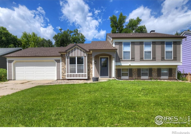 137 S Polk Ave, Louisville, CO 80027 - split level home featuring stone siding, a front yard, a garage, and concrete driveway