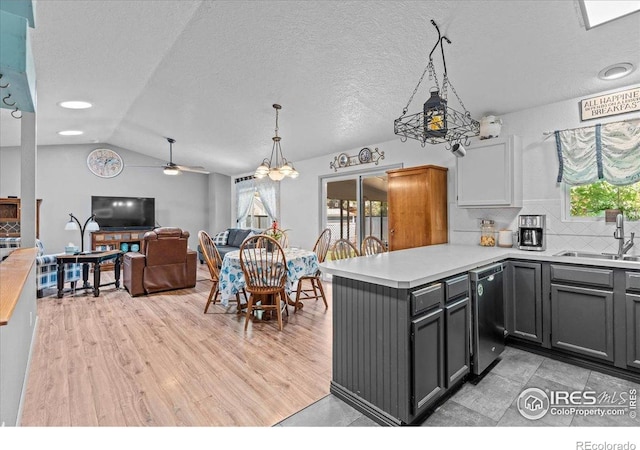 110 50th Ave, Greeley, CO 80634 - kitchen with dishwasher, a peninsula, light countertops, plenty of natural light, and vaulted ceiling
