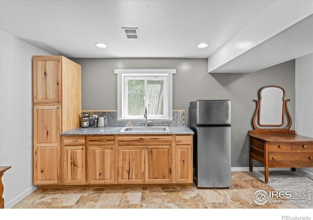 110 50th Ave, Greeley, CO 80634 - kitchen with freestanding refrigerator, tasteful backsplash, light countertops, and recessed lighting