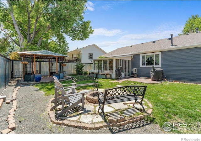 110 50th Ave, Greeley, CO 80634 - fenced backyard featuring an outdoor fire pit, a sunroom, and a patio
