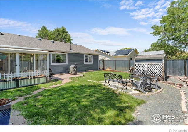 110 50th Ave, Greeley, CO 80634 - fenced backyard with a fire pit and a storage unit