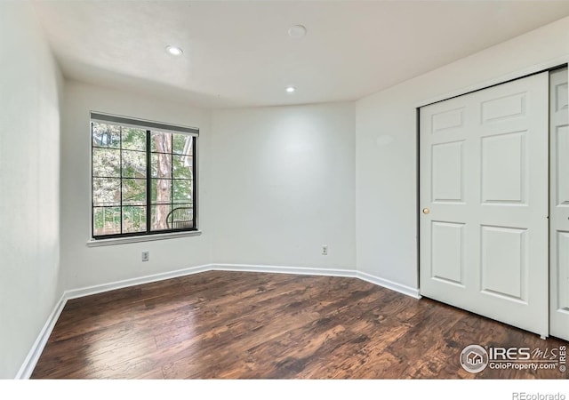 4771 White Rock Cir Unit B, Boulder, CO 80301 - unfurnished bedroom featuring dark wood-type flooring, recessed lighting, and a closet