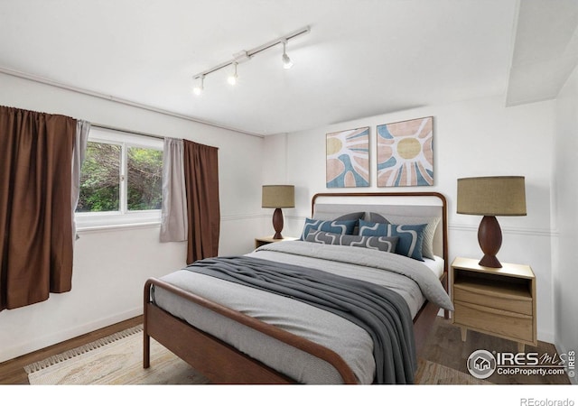 1512 Brentwood Dr, Fort Collins, CO 80521 - bedroom featuring rail lighting and wood finished floors