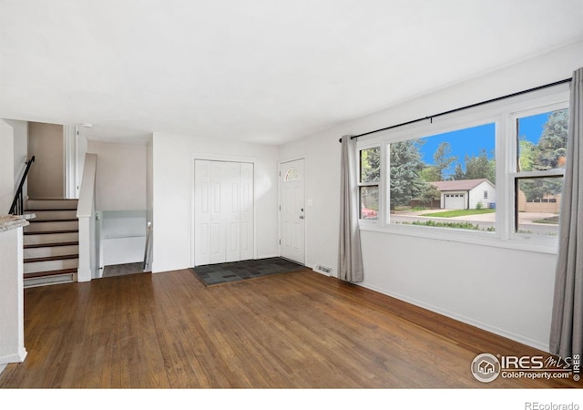 1512 Brentwood Dr, Fort Collins, CO 80521 - unfurnished living room featuring wood finished floors and stairs