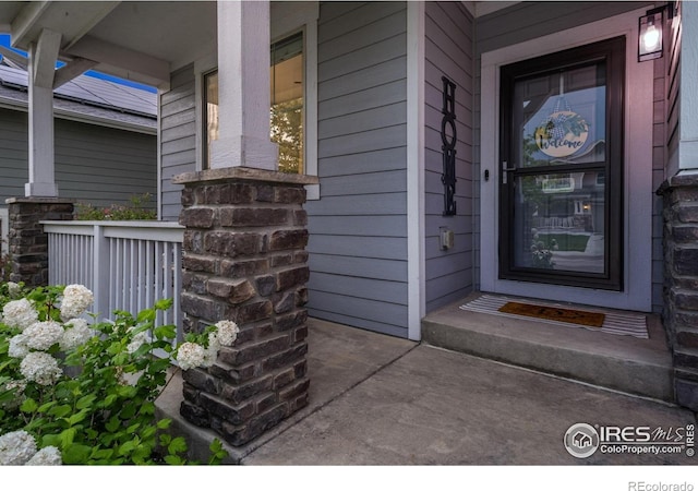 6420 Tuxedo Park Rd, Timnath, CO 80547 - doorway to property featuring covered porch