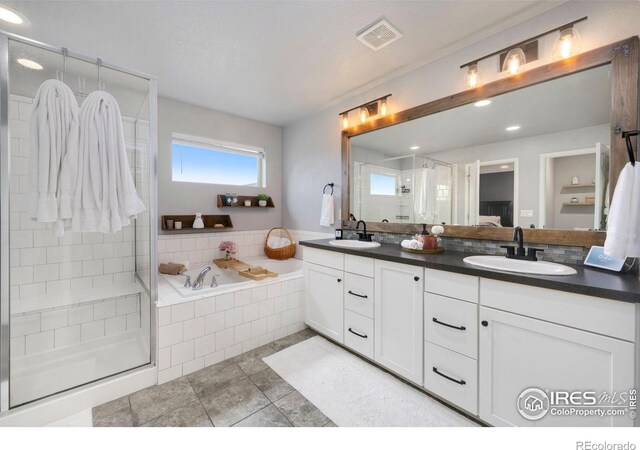 6420 Tuxedo Park Rd, Timnath, CO 80547 - bathroom with double vanity, a stall shower, a bath, tile patterned floors, and recessed lighting