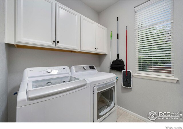 6420 Tuxedo Park Rd, Timnath, CO 80547 - laundry area featuring separate washer and dryer, cabinet space, and light tile patterned flooring