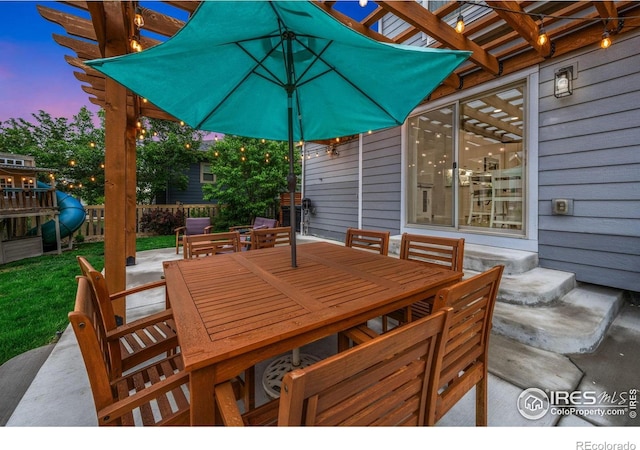 6420 Tuxedo Park Rd, Timnath, CO 80547 - patio terrace at dusk featuring outdoor dining area and a patio area