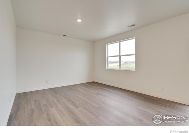 1639 Pinnacle Ave, Lochbuie, CO 80603 - unfurnished room with wood finished floors and recessed lighting