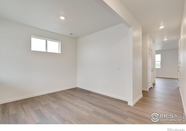 1639 Pinnacle Ave, Lochbuie, CO 80603 - spare room featuring wood finished floors, recessed lighting, and plenty of natural light