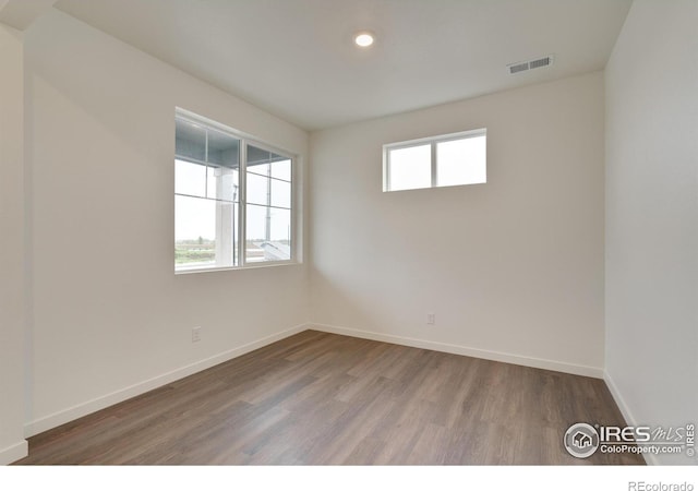 1639 Pinnacle Ave, Lochbuie, CO 80603 - unfurnished room with wood finished floors and recessed lighting