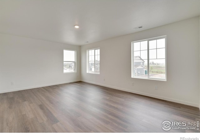 1639 Pinnacle Ave, Lochbuie, CO 80603 - unfurnished room featuring wood finished floors and recessed lighting